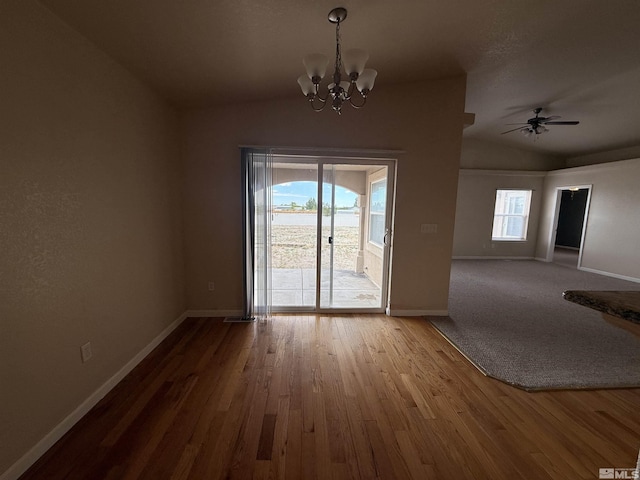 5740 Sarah Rd, Fallon, NV 89406 - unfurnished dining area with lofted ceiling, baseboards, a chandelier, wood finished floors, and a ceiling fan