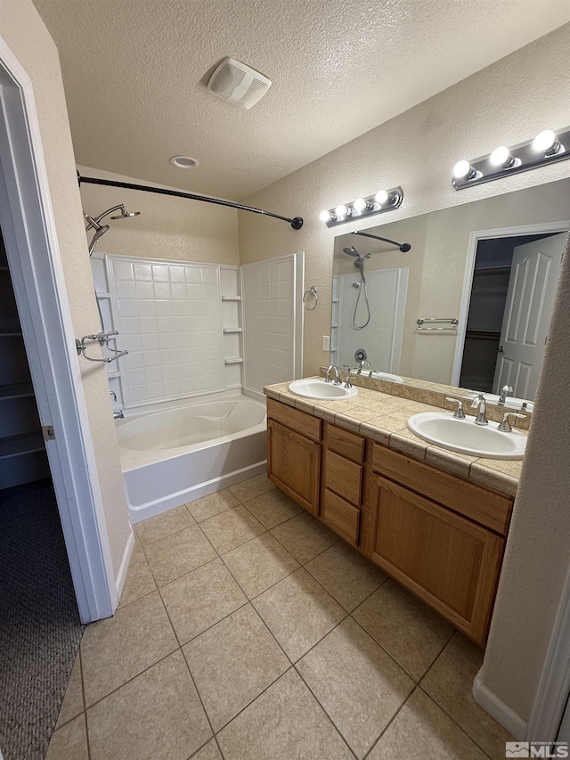 5740 Sarah Rd, Fallon, NV 89406 - bathroom featuring a textured ceiling, tile patterned flooring, shower / bathtub combination, a textured wall, and double vanity