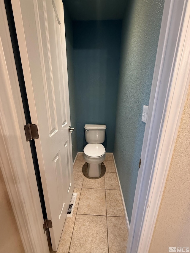 5740 Sarah Rd, Fallon, NV 89406 - bathroom with toilet, tile patterned flooring, baseboards, and a textured wall