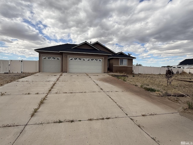 5740 Sarah Rd, Fallon, NV 89406 - ranch-style house with concrete driveway, an attached garage, and fence