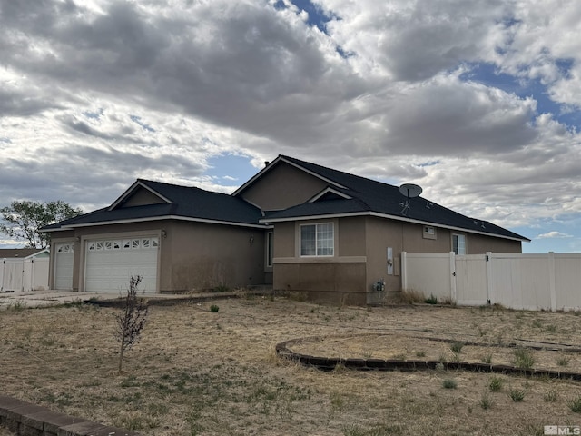 5740 Sarah Rd, Fallon, NV 89406 - view of front of property with an attached garage, fence, and stucco siding