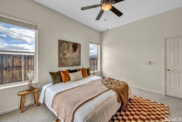 bedroom with baseboards, light carpet, and a ceiling fan