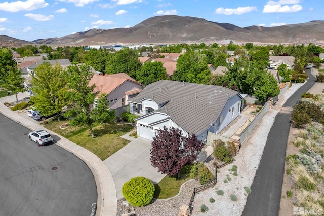 aerial view of residential area featuring a mountainous background