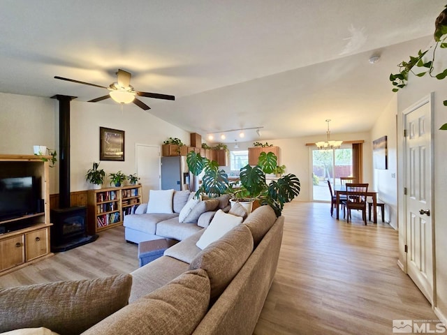 961 Ruddy Ct, Sparks, NV 89441 - living room with a wood stove, lofted ceiling, light wood-style floors, ceiling fan, and a chandelier