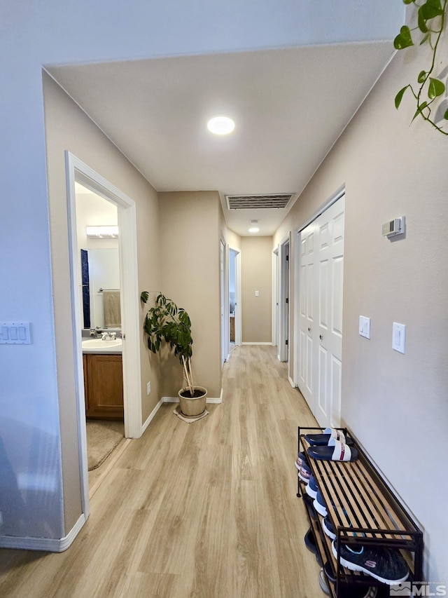 961 Ruddy Ct, Sparks, NV 89441 - corridor featuring light wood finished floors, a sink, and baseboards