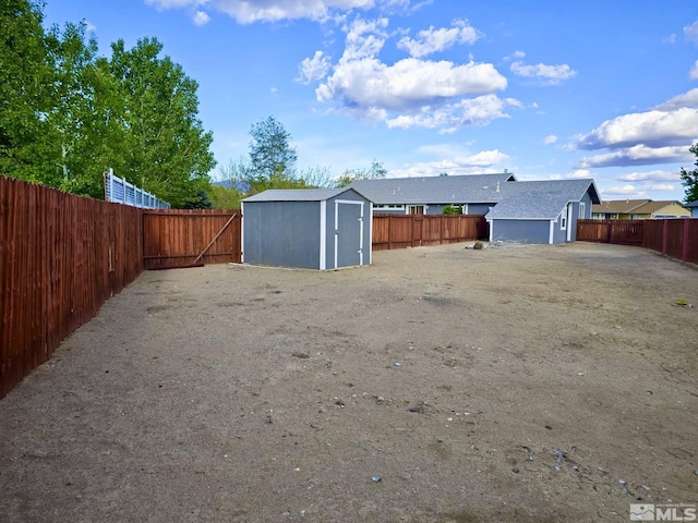 961 Ruddy Ct, Sparks, NV 89441 - fenced backyard featuring a storage unit and an outbuilding
