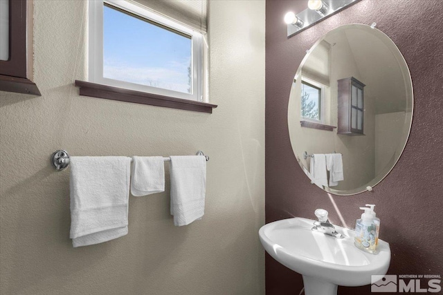 bathroom with a sink and a textured wall