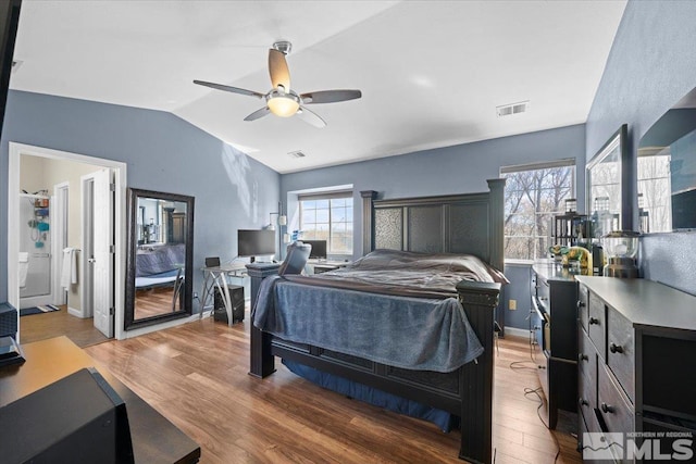 bedroom with vaulted ceiling, wood finished floors, and a ceiling fan