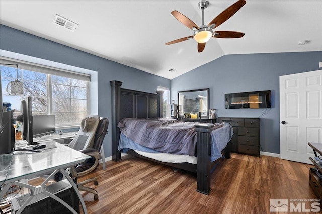 bedroom with vaulted ceiling, wood finished floors, a desk, and baseboards