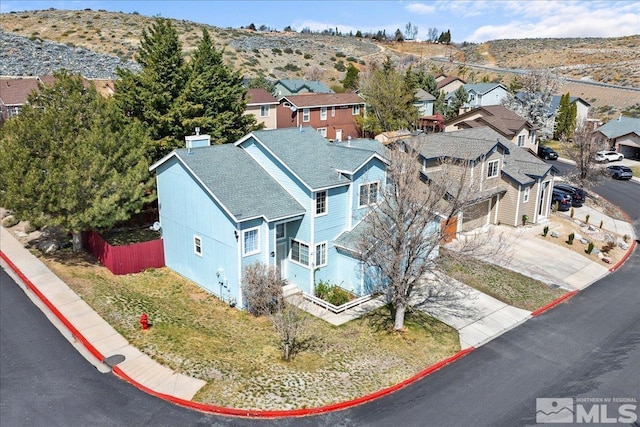 aerial view of residential area featuring a mountain backdrop