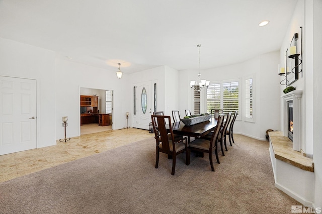 6570 Rey Del Sierra Ct, Sparks, NV 89436 - carpeted dining space with a chandelier, a warm lit fireplace, recessed lighting, and baseboards