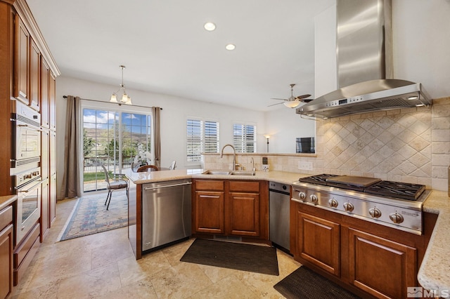 6570 Rey Del Sierra Ct, Sparks, NV 89436 - kitchen featuring appliances with stainless steel finishes, a sink, wall chimney exhaust hood, tasteful backsplash, and a ceiling fan