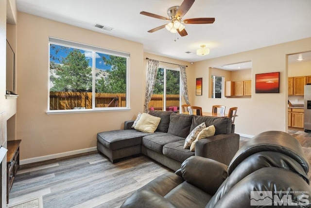 2190 Canyon Mesa Ct, Reno, NV 89523 - living room with light wood-style floors, ceiling fan, and baseboards