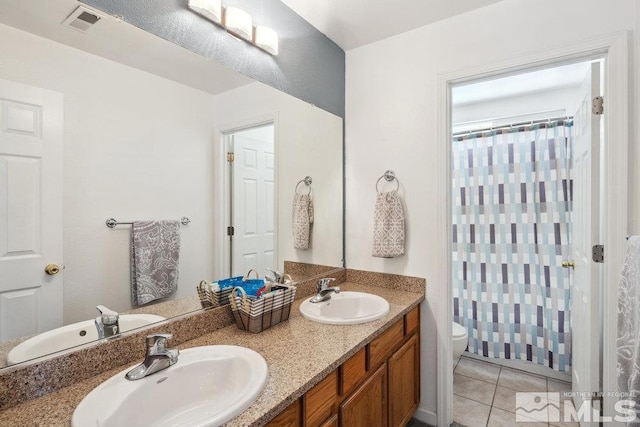 2190 Canyon Mesa Ct, Reno, NV 89523 - full bath with toilet, double vanity, a shower with shower curtain, and tile patterned flooring