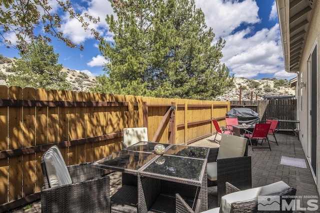 2190 Canyon Mesa Ct, Reno, NV 89523 - view of patio with outdoor dining area, a fenced backyard, and a grill