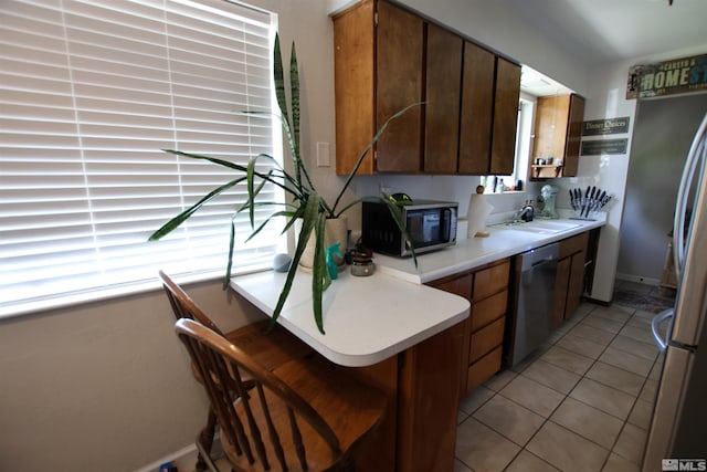 435 Shipley Dr, Yerington, NV 89447 - kitchen featuring stainless steel appliances, a sink, light countertops, a peninsula, and light tile patterned floors