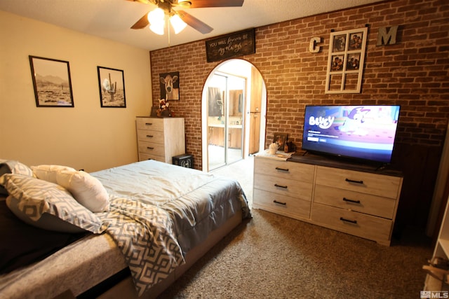 435 Shipley Dr, Yerington, NV 89447 - bedroom featuring carpet floors, brick wall, a ceiling fan, and arched walkways