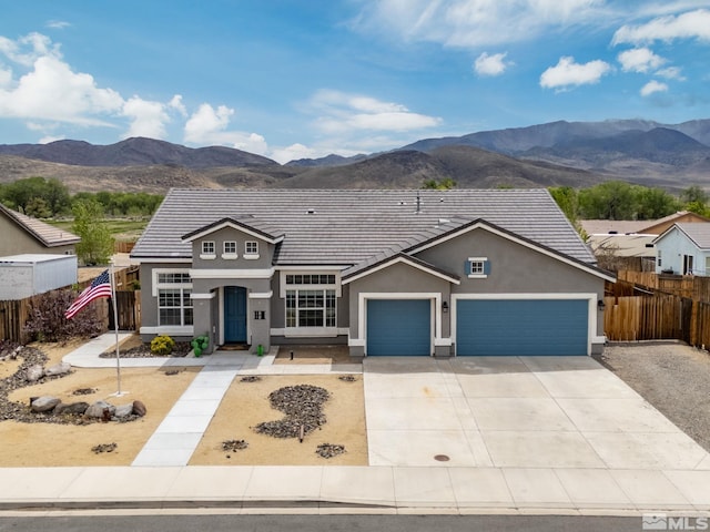 1523 Riverpark Pkwy, Dayton, NV 89403 - traditional home with fence, a mountain view, stucco siding, and a garage