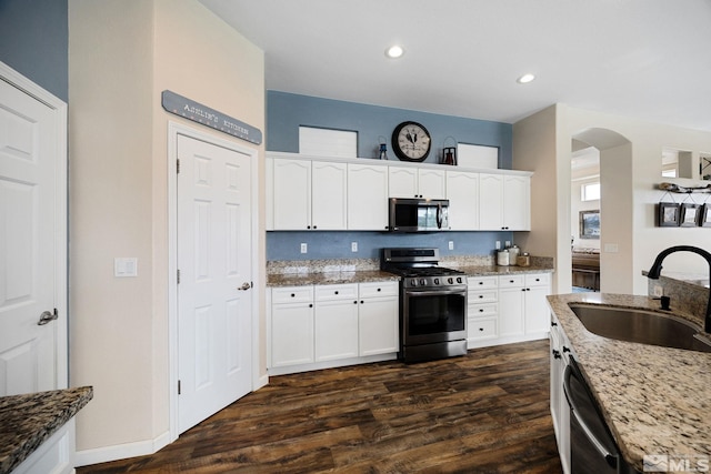 1523 Riverpark Pkwy, Dayton, NV 89403 - kitchen featuring stainless steel appliances, a sink, light stone countertops, dark wood-style floors, and recessed lighting
