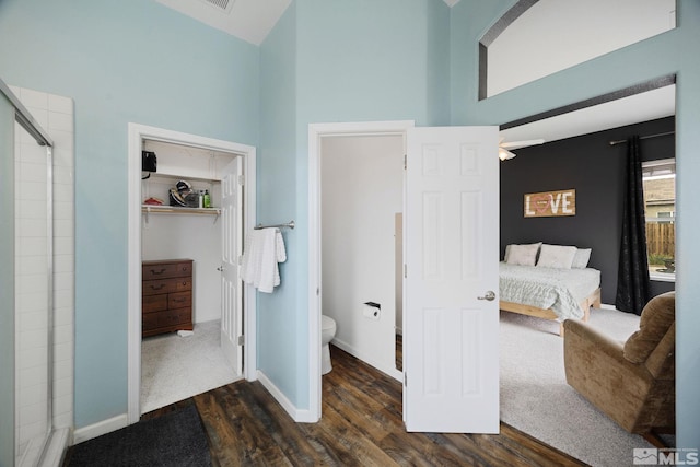 1523 Riverpark Pkwy, Dayton, NV 89403 - bedroom featuring dark wood-type flooring, high vaulted ceiling, baseboards, a walk in closet, and a closet