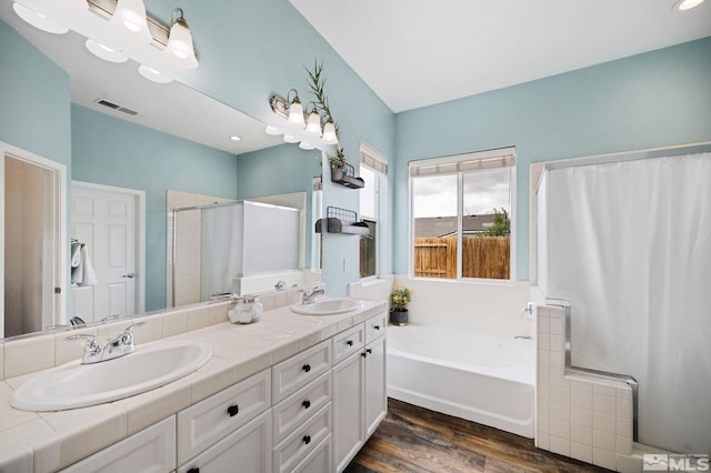 1523 Riverpark Pkwy, Dayton, NV 89403 - full bathroom featuring a garden tub, wood finished floors, double vanity, and a shower stall