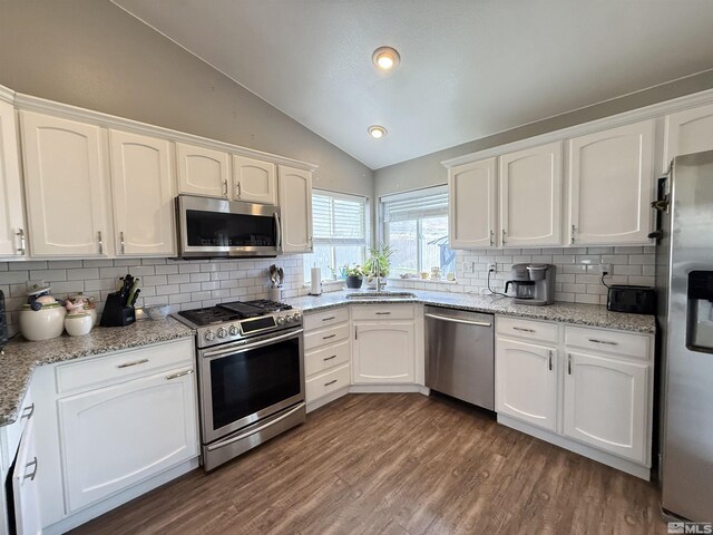 660 Castle Way, Winnemucca, NV 89445 - kitchen featuring appliances with stainless steel finishes, vaulted ceiling, a sink, white cabinetry, and recessed lighting