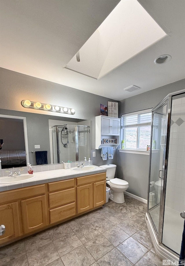 660 Castle Way, Winnemucca, NV 89445 - ensuite bathroom with double vanity, a shower stall, and toilet