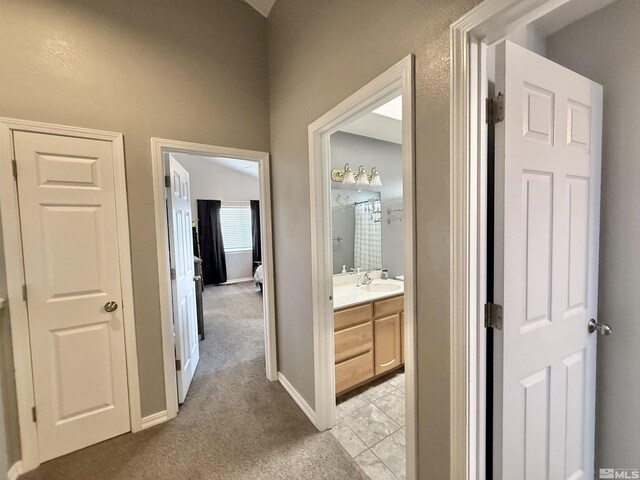 660 Castle Way, Winnemucca, NV 89445 - corridor with a sink, light carpet, and baseboards