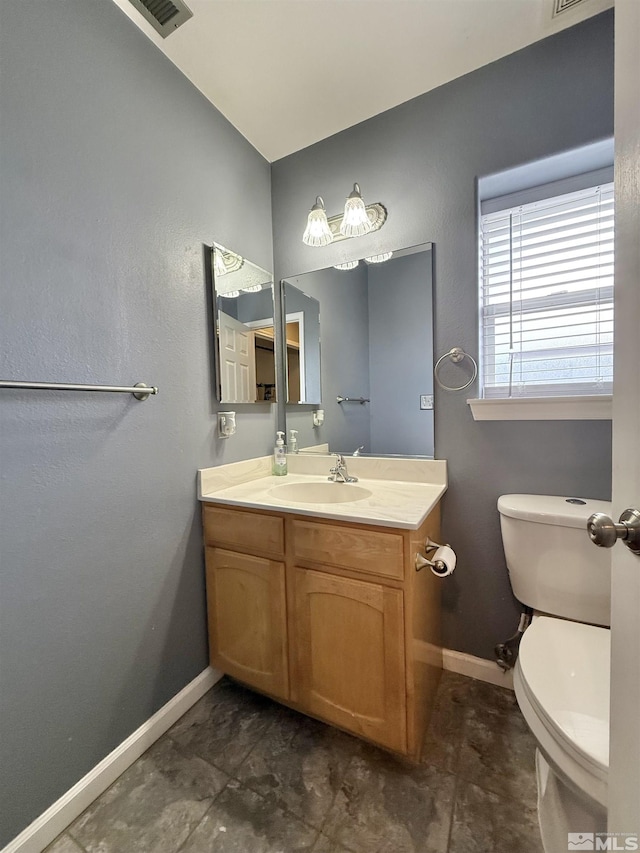 660 Castle Way, Winnemucca, NV 89445 - half bath featuring baseboards, vanity, and toilet