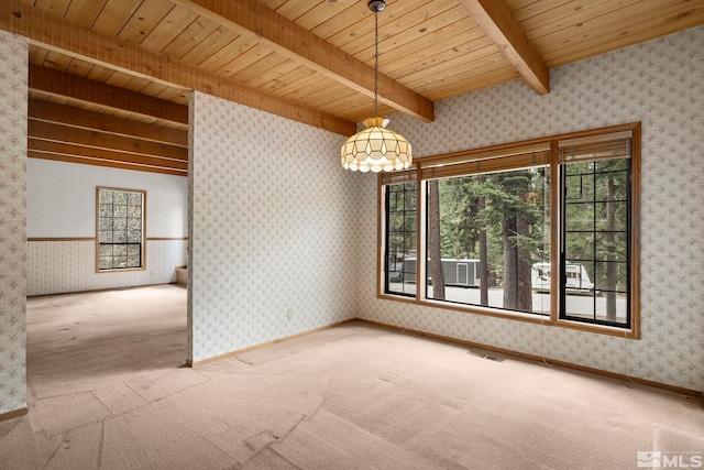 spare room featuring beam ceiling, wooden ceiling, carpet flooring, wallpapered walls, and healthy amount of natural light