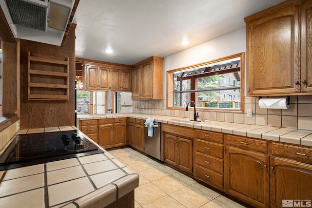 kitchen featuring a sink, stainless steel dishwasher, backsplash, brown cabinets, and recessed lighting