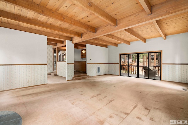 carpeted empty room with wallpapered walls, wainscoting, wooden ceiling, and beamed ceiling