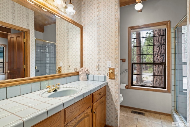 bathroom featuring a shower stall, tile patterned flooring, vanity, and toilet