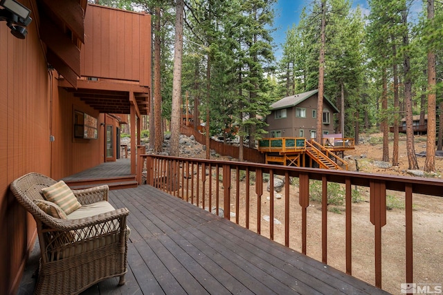 wooden deck with view of scattered trees