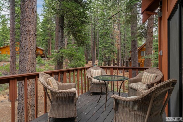 deck with outdoor dining area