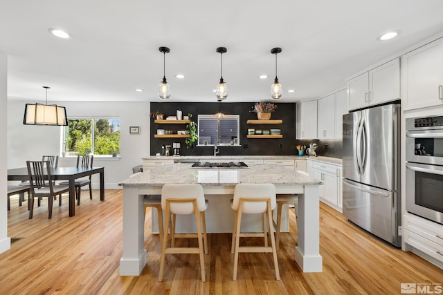 2480 Idlewild Dr, Reno, NV 89509 - kitchen with appliances with stainless steel finishes, open shelves, white cabinetry, light wood-style flooring, and recessed lighting