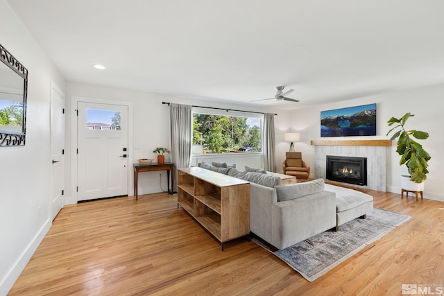 2480 Idlewild Dr, Reno, NV 89509 - living area with light wood finished floors, ceiling fan, a tiled fireplace, baseboards, and recessed lighting