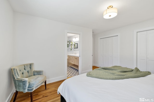 2480 Idlewild Dr, Reno, NV 89509 - bedroom featuring light wood-style flooring, multiple closets, baseboards, and ensuite bath
