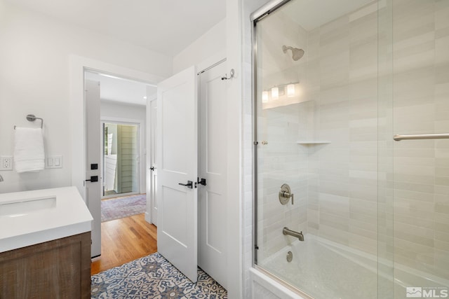 2480 Idlewild Dr, Reno, NV 89509 - bathroom featuring combined bath / shower with glass door, vanity, and wood finished floors