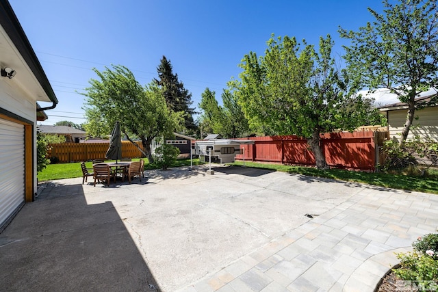 2480 Idlewild Dr, Reno, NV 89509 - view of patio featuring outdoor dining space, a fenced backyard, and an outbuilding
