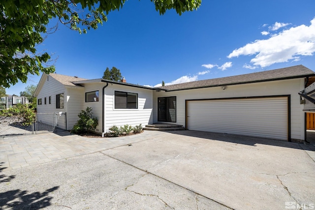 2480 Idlewild Dr, Reno, NV 89509 - ranch-style house with an attached garage, a gate, driveway, and fence