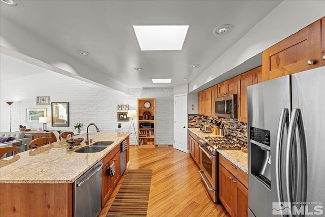 3425 Skyline Blvd, Reno, NV 89509 - kitchen with appliances with stainless steel finishes, a sink, light wood-style floors, and brown cabinets