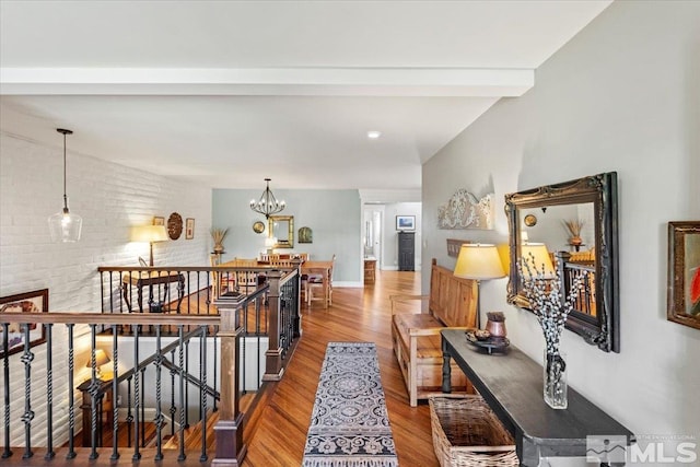 3425 Skyline Blvd, Reno, NV 89509 - hall featuring an upstairs landing, wood finished floors, a chandelier, brick wall, and beamed ceiling