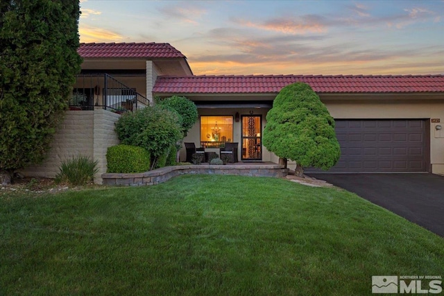 3425 Skyline Blvd, Reno, NV 89509 - view of front facade with driveway, an attached garage, a tile roof, a front yard, and stucco siding