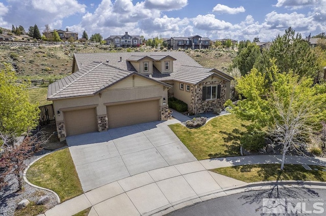 view of front facade featuring stone siding, an attached garage, concrete driveway, and stucco siding