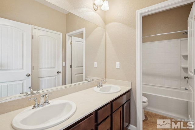 bathroom featuring toilet, double vanity, shower / tub combination, and tile patterned flooring