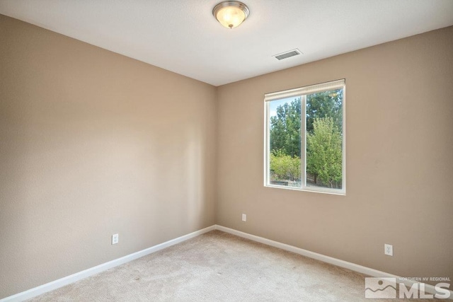 unfurnished room with baseboards and light carpet