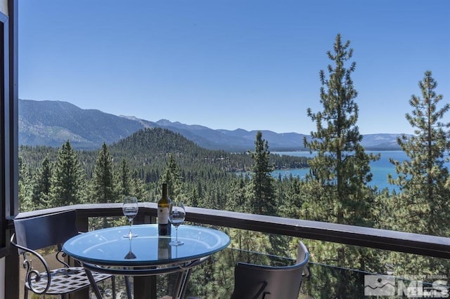 view of mountain backdrop featuring a heavily wooded area