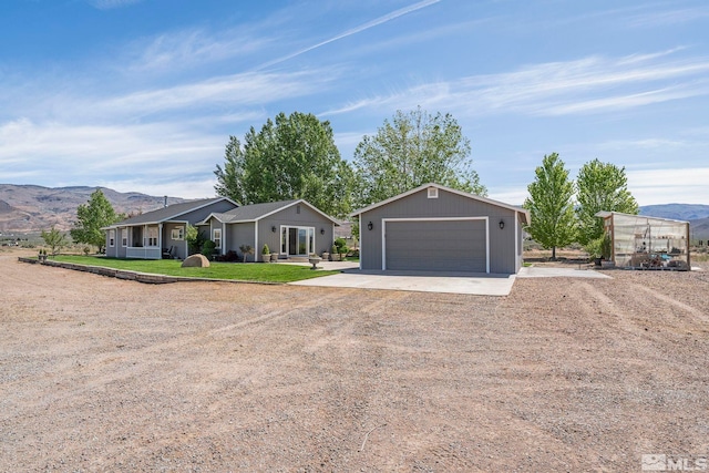 4800 Amy Rd, Reno, NV 89510 - ranch-style home featuring dirt driveway, an outdoor structure, a mountain view, and a front lawn