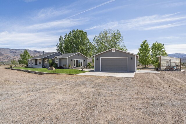 4800 Amy Rd, Reno, NV 89510 - ranch-style house with driveway, an outbuilding, a mountain view, and a front lawn